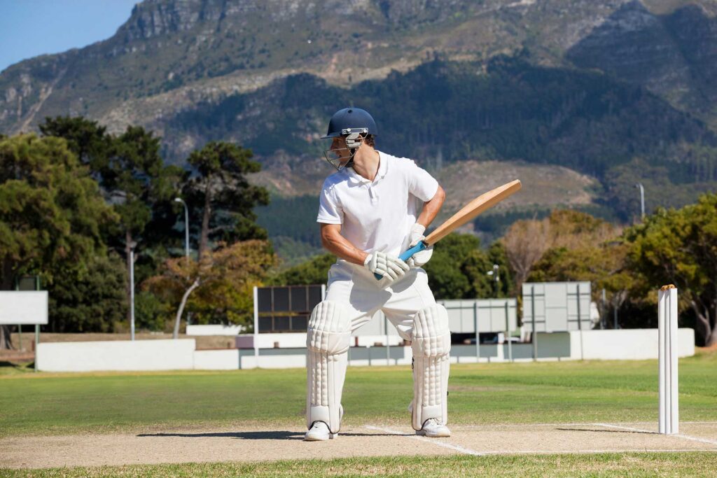 batsman-playing-cricket-on-field-against-mountain-2025-04-03-11-37-09-utc.jpg