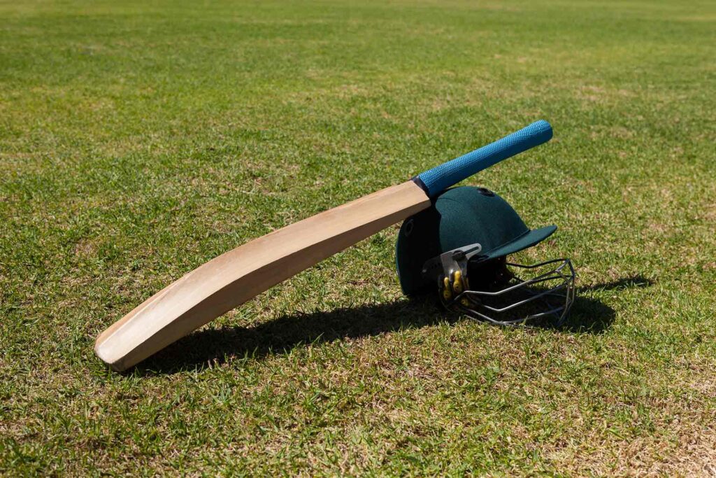 high-angle-view-of-cricket-bat-and-helmet-on-field-2025-04-03-15-41-32-utc.jpg